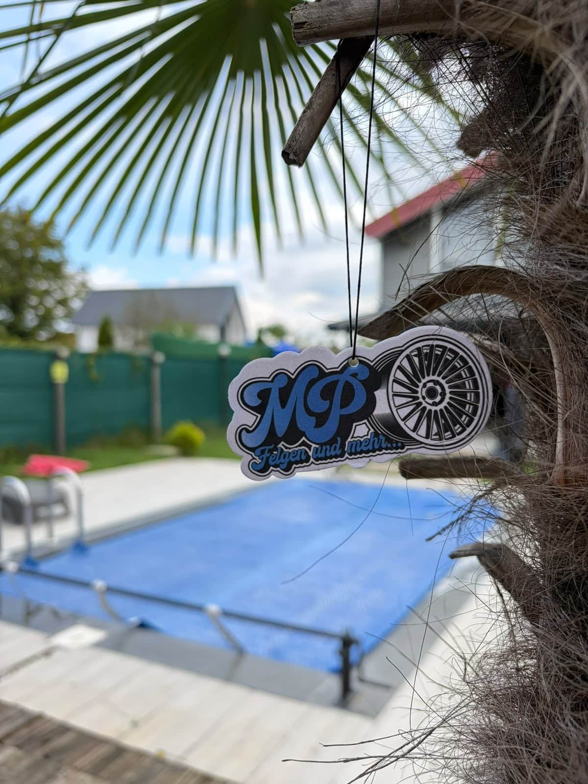 Car air freshener with logo die-cut as a wheel rim for a wheel retailer